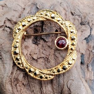 Vintage Gold-Tone Wreath Brooch with Dark Red Accent Stone